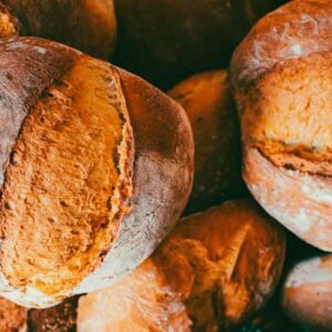 Home Freshly baked artisan bread with golden crust, perfect for bakeries and culinary websites.