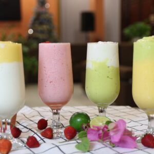 A vibrant array of healthy fruit smoothies in wine glasses, perfect for a balanced diet.