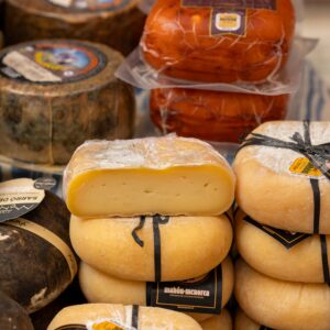 Assorted traditional Spanish cheeses displayed at a market stall in Palma, Spain.