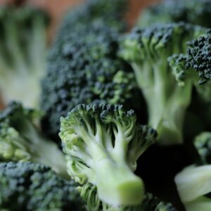 Close-up of fresh green broccoli florets on a kitchen chopping board, ready for cooking.